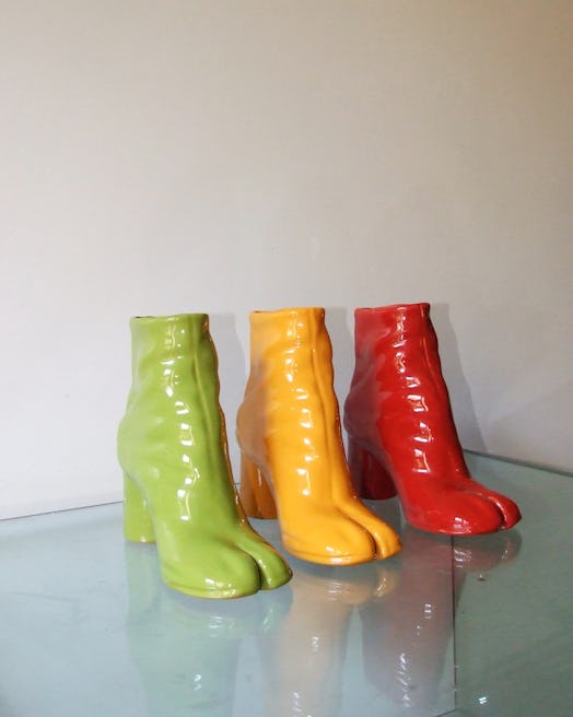 Ceramic sculptures shaped like Margiela Tabi boots in green, yellow and red 