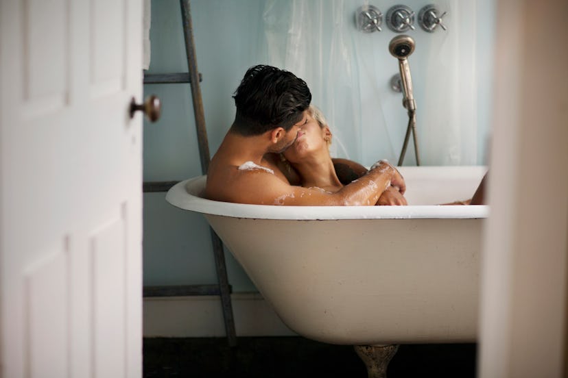 Couple kissing in bathtub