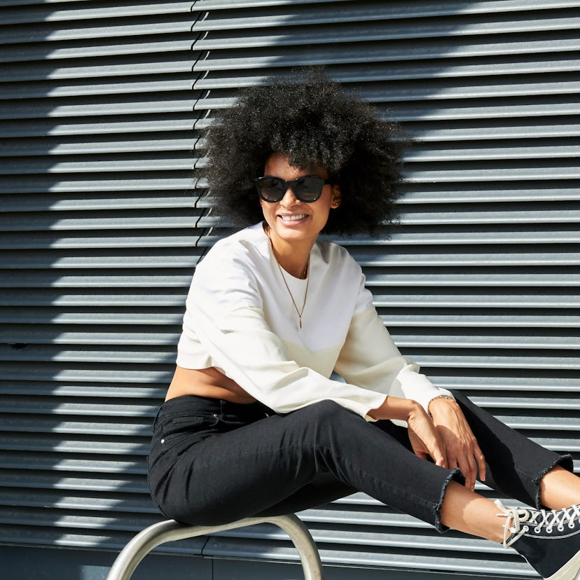 Young woman smiling, having the best week of June 21, 2021, per her zodiac sign.