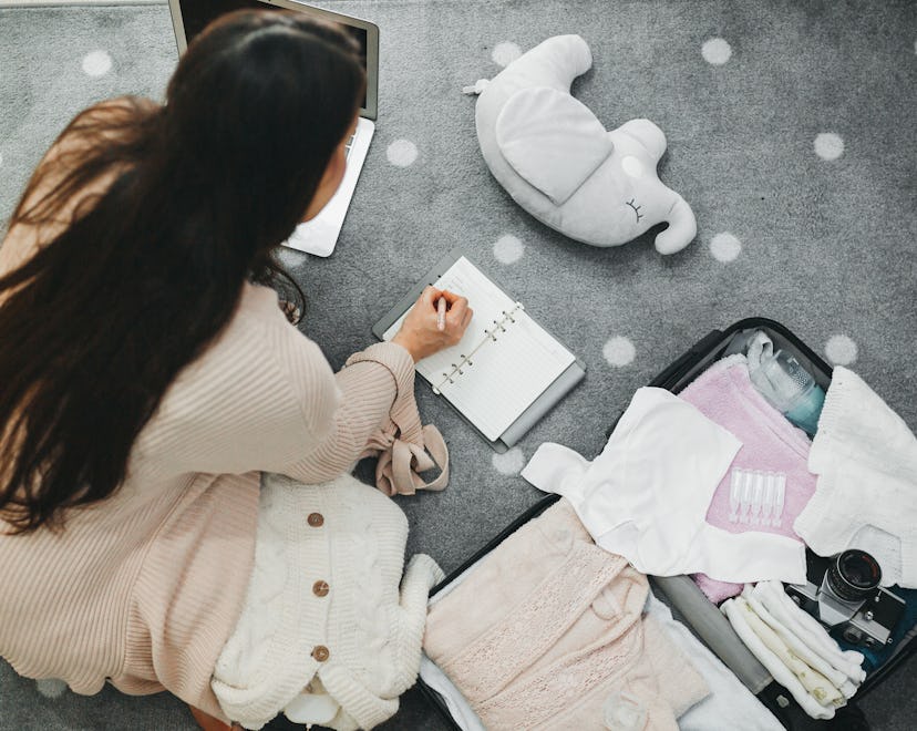 woman packing hospital bag and checking things off the list