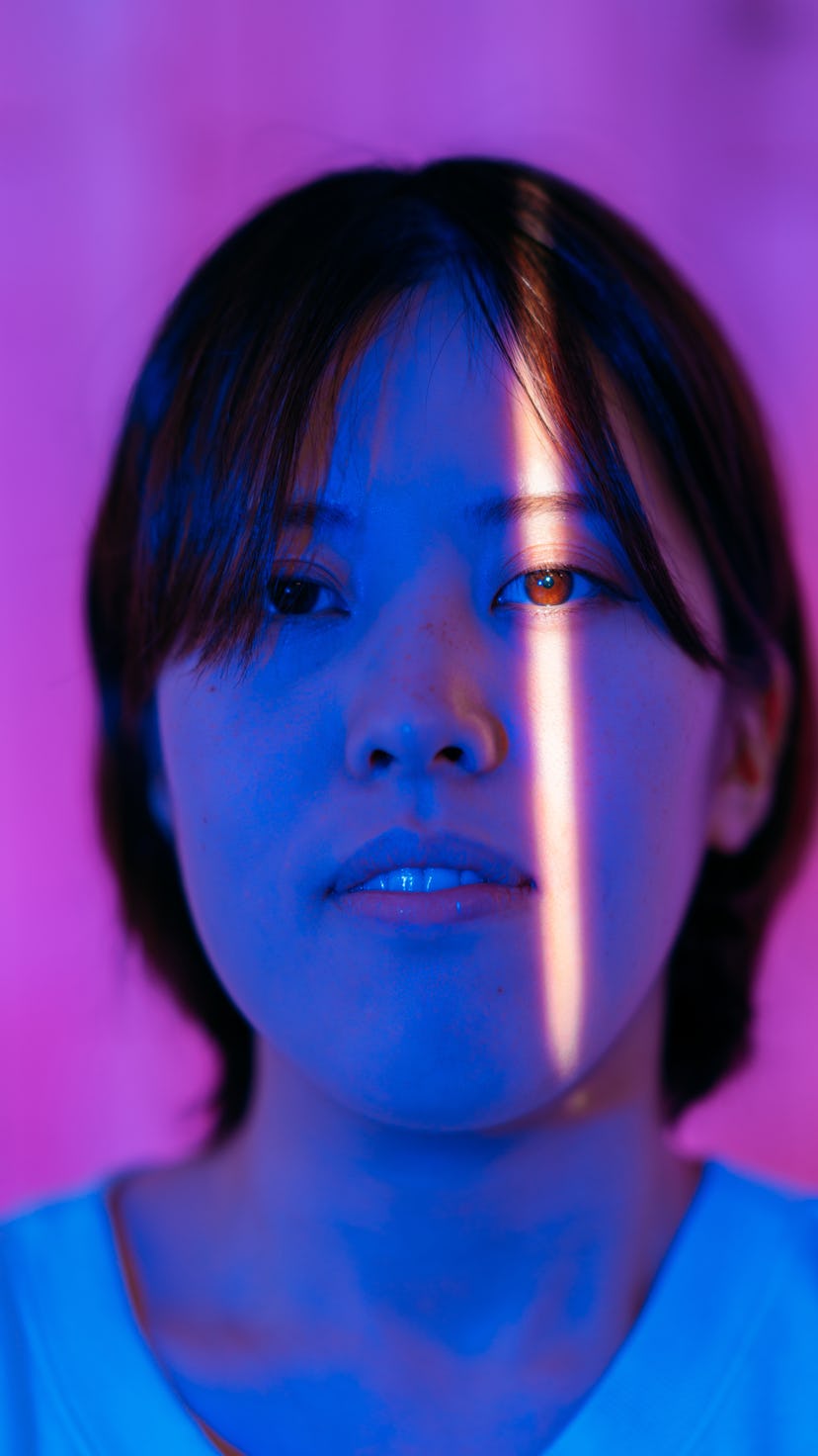 Young woman with light shining across one eyes when Mercury retrograde spring 2021 ends.