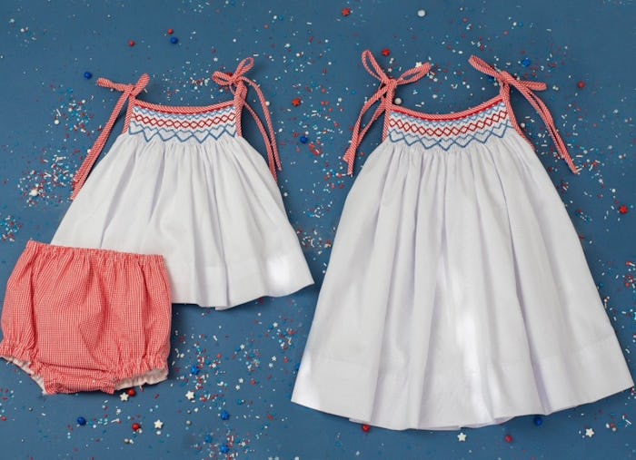 Image of toddler-size white smocked jumper and red bottoms, alongside a matching smocked jumper in a...