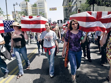 Untitled #5 (Peace March, Los Angeles, CA) with a group of women marching with American flags by Cat...