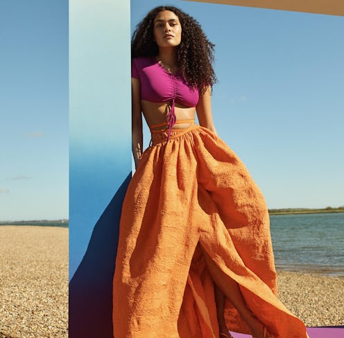 Model wearing a billowy skirt and a crop top for a Net-a-Porter campaign. 