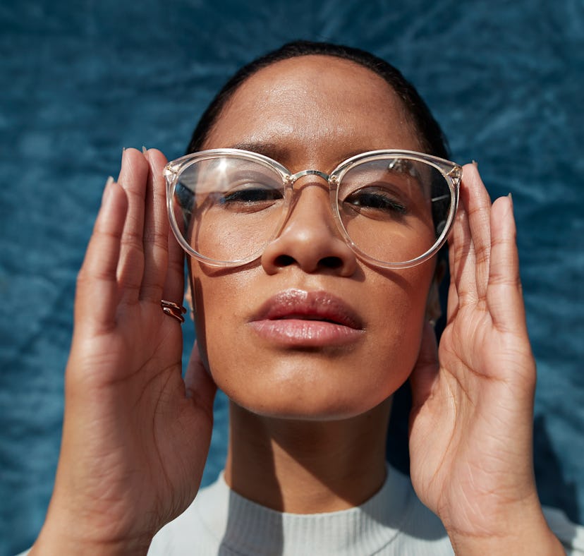 Young woman with big glasses studying the astrology elements and their meanings.