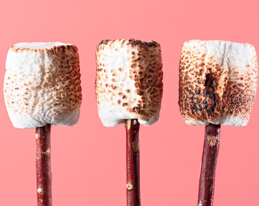 Three toasted marshmallows on sticks 