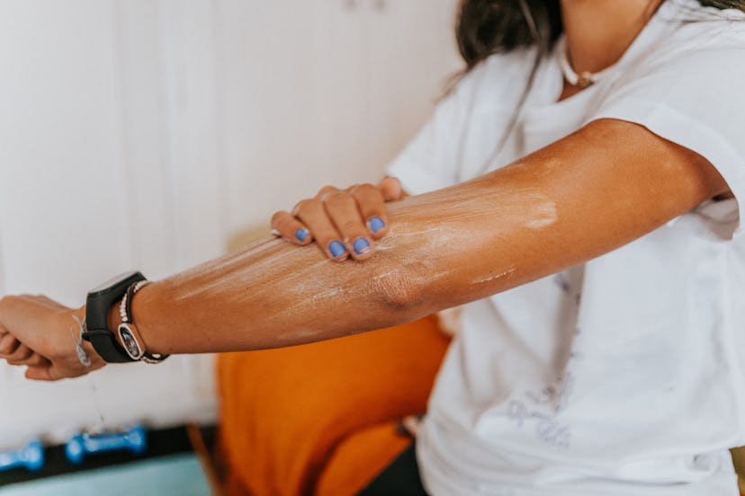 Woman applying sunscreen to her arm