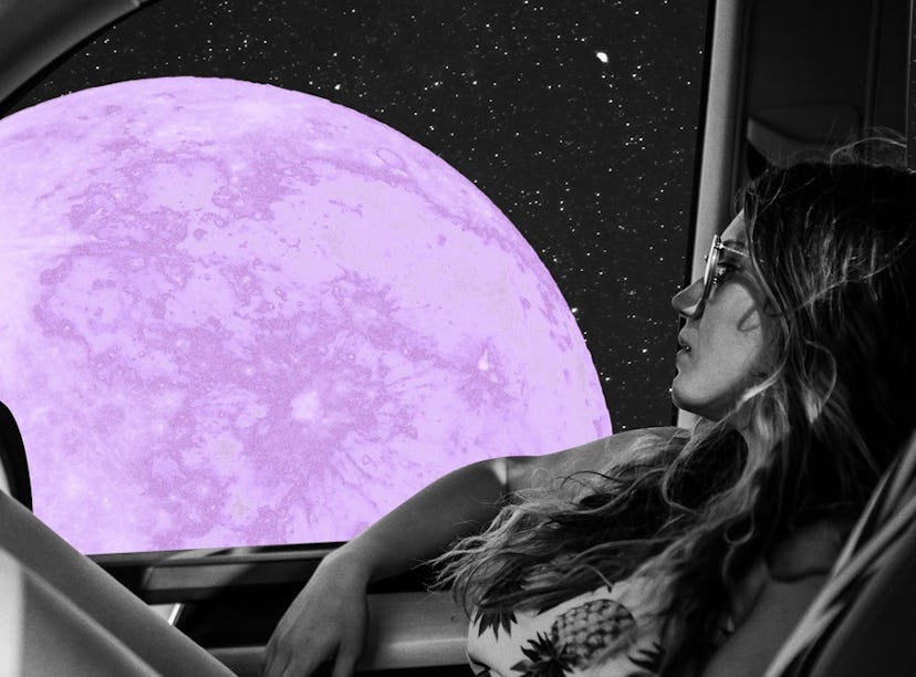 Young woman staring at a full moon from her car before reading her June 2021 full moon horoscope.