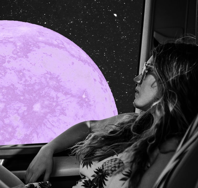 Young woman staring at a full moon from her car before reading her June 2021 full moon horoscope.