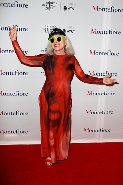 Debbie Harry in a red dress, black cap and green sunglasses at the Tribeca Film Festival