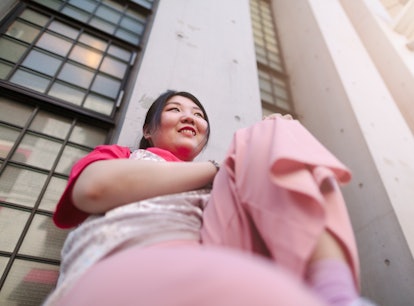 Smiling young woman wearing all pink, having the best time during the June 2021 full moon.