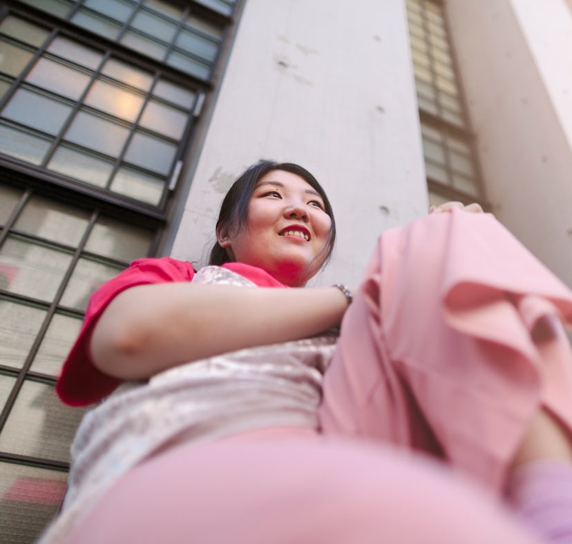 Smiling young woman wearing all pink, having the best time during the June 2021 full moon.