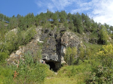 Entrance to Denisova cave in mountains