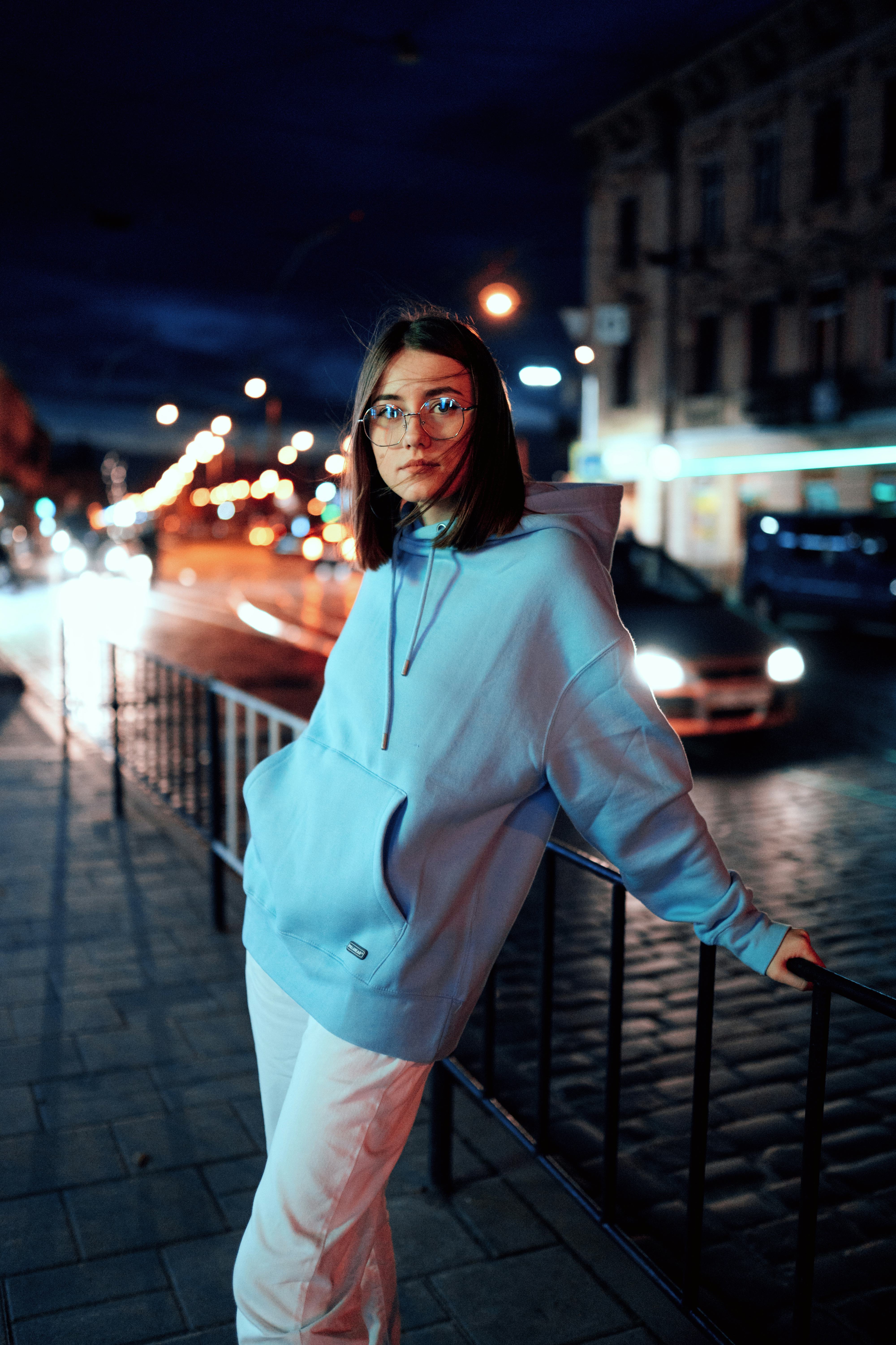 Young woman with glasses standing outside during Neptune retrograde 2021.