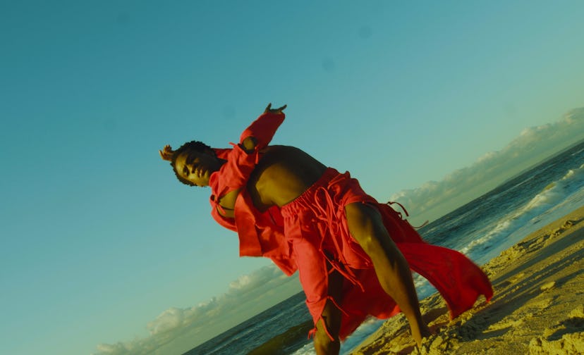 Model wearing a red beach set by Queera