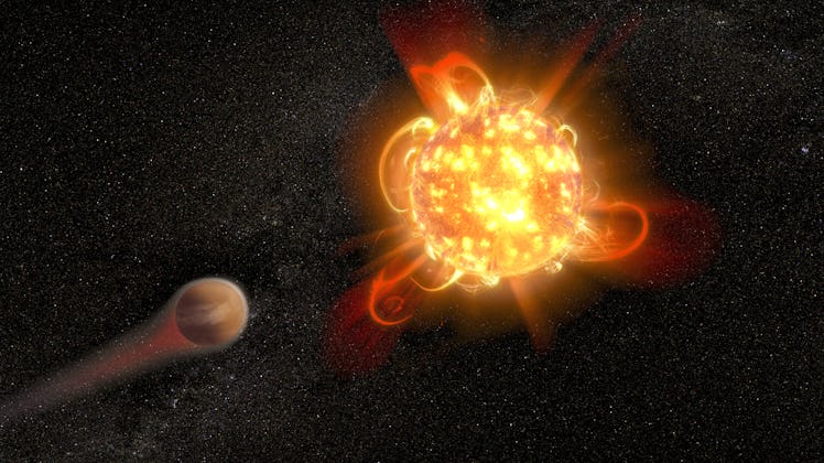 An illustration of a red dwarf star and an orbiting planet.