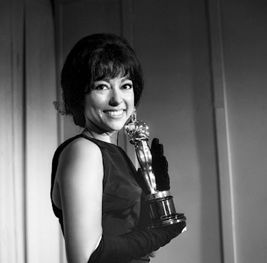 Rita Moreno posing with her Oscar Best Supporting Actress trophy