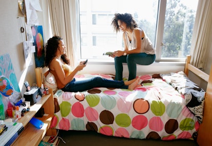 Roommates in their dorm, living the college life before posting a picture on Instagram with a fun ca...