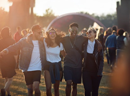 Group of friends at a music festival before posting a pic on Instagram with a squad caption.