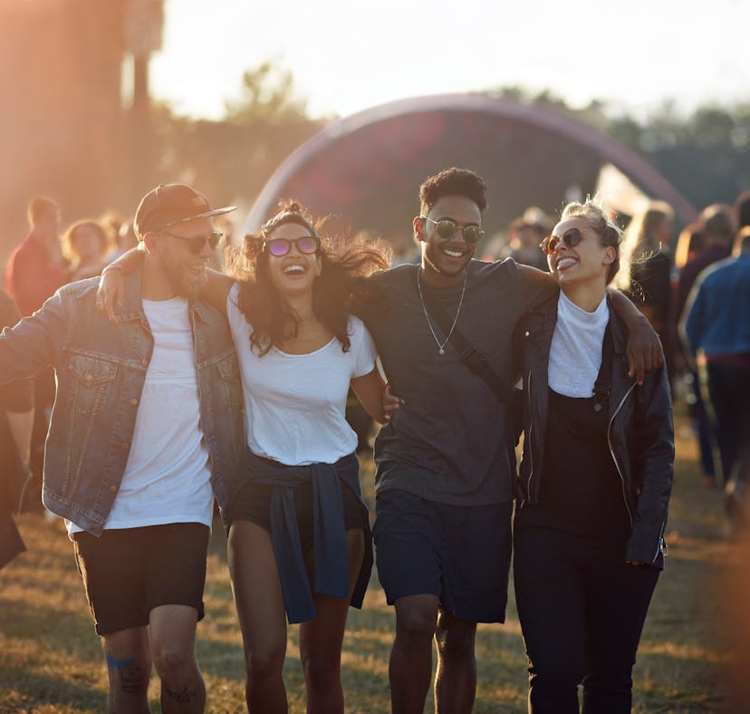Group of friends at a music festival before posting a pic on Instagram with a squad caption.