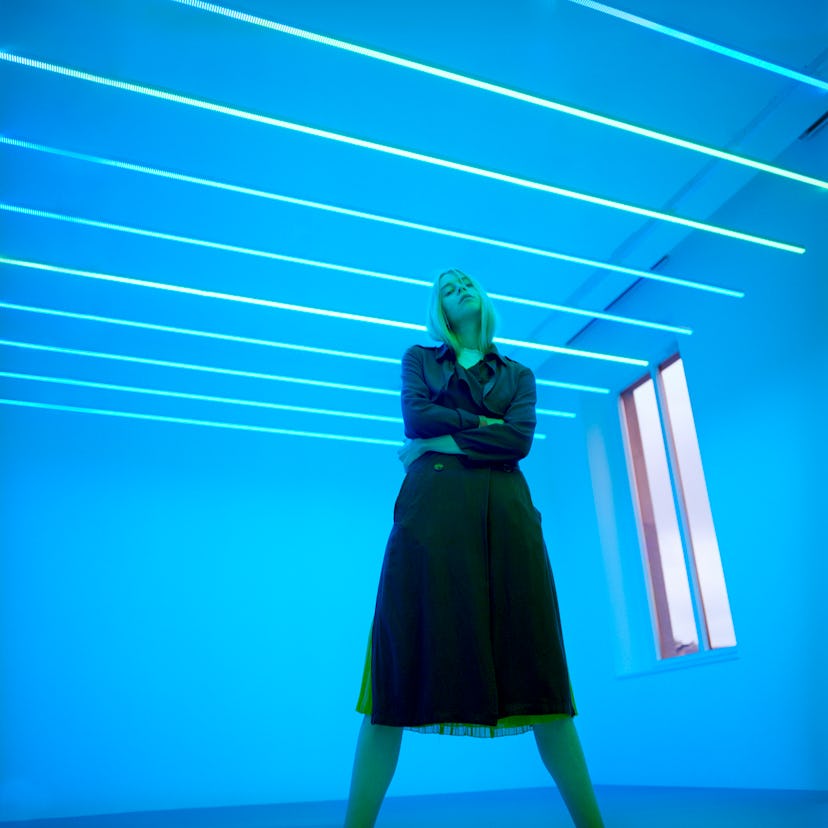 Young woman in neon blue lights to describe what planet rules Tuesday, what planet rules Wednesday, ...