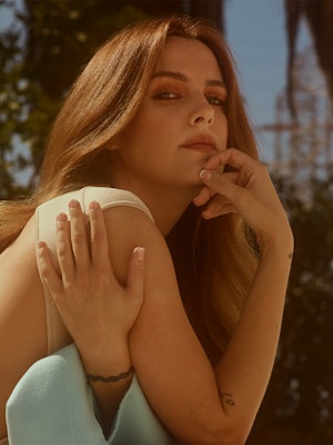 A closeup of 'Zola' star Riley Keough posing outside for Bustle's cover.