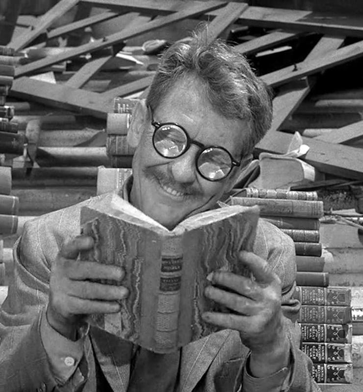 man with glasses reading book in still from the twilight zone series