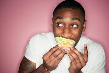 man eating a cupcake