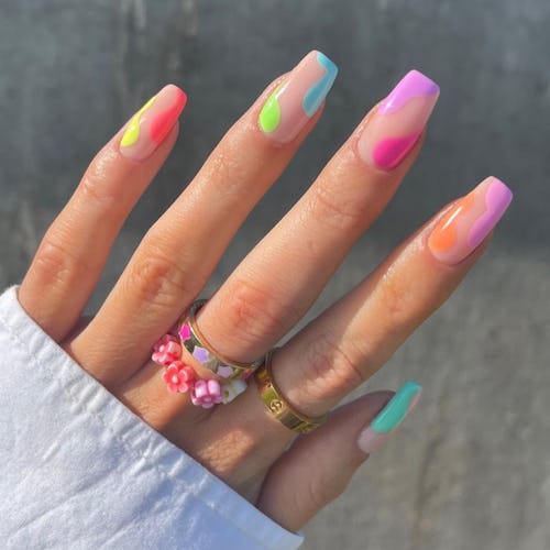 A close-up a woman hands with one of the best summer nail designs we're seeing all over Instagram