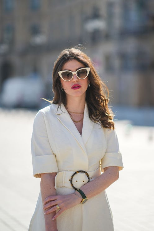 Woman wearing sunglasses and a dress in the sun