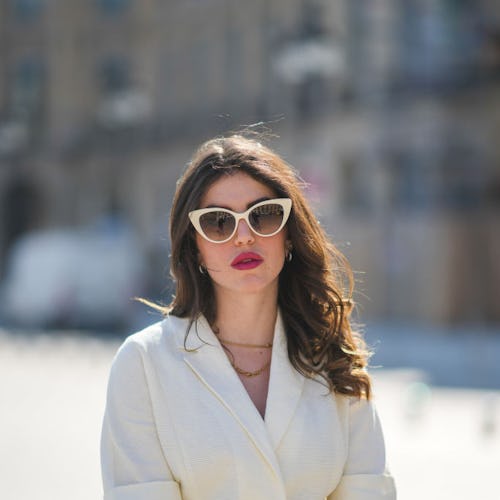 Woman wearing sunglasses and a dress in the sun