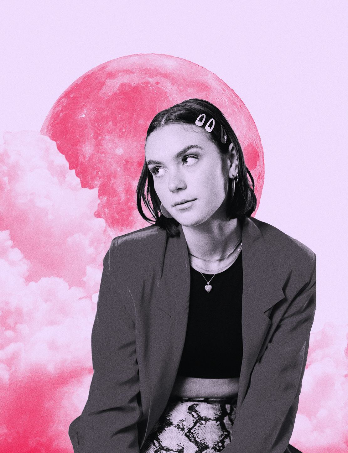 Young woman with clips in her hair in front of a pink moon while reading her July 2021 monthly horos...