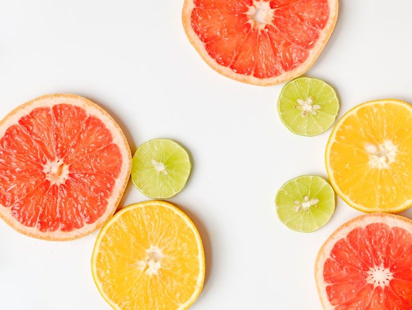 assorted sliced citrus fruits on white background