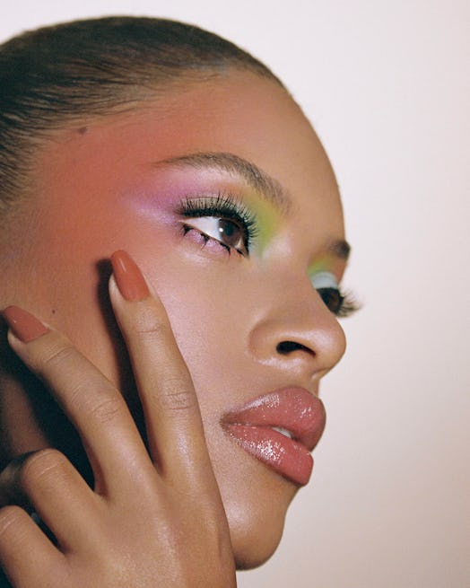 A model showing off a Raoúl Alejandre multicolored makeup look with pink, green and light blue eyesh...