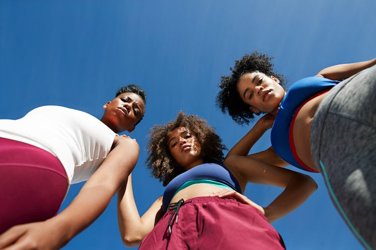 3 young woman looking down at the camera after learning Leo-Virgo "cusp babies" aren't real.