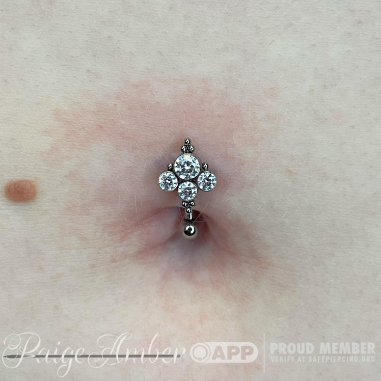 A floating navel piercing done by Paige Amber Holloway.