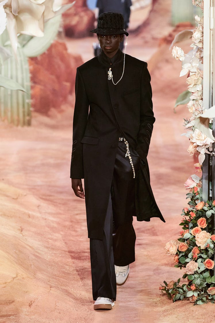 A model in a black suit by Dior at Men’s Fashion Week Spring 2022