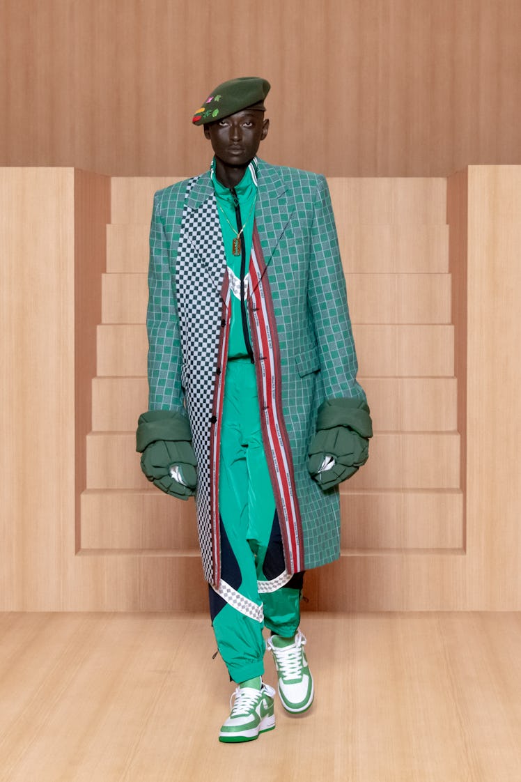 A spring 2022 men's Louis Vuitton model wearing giant gloves