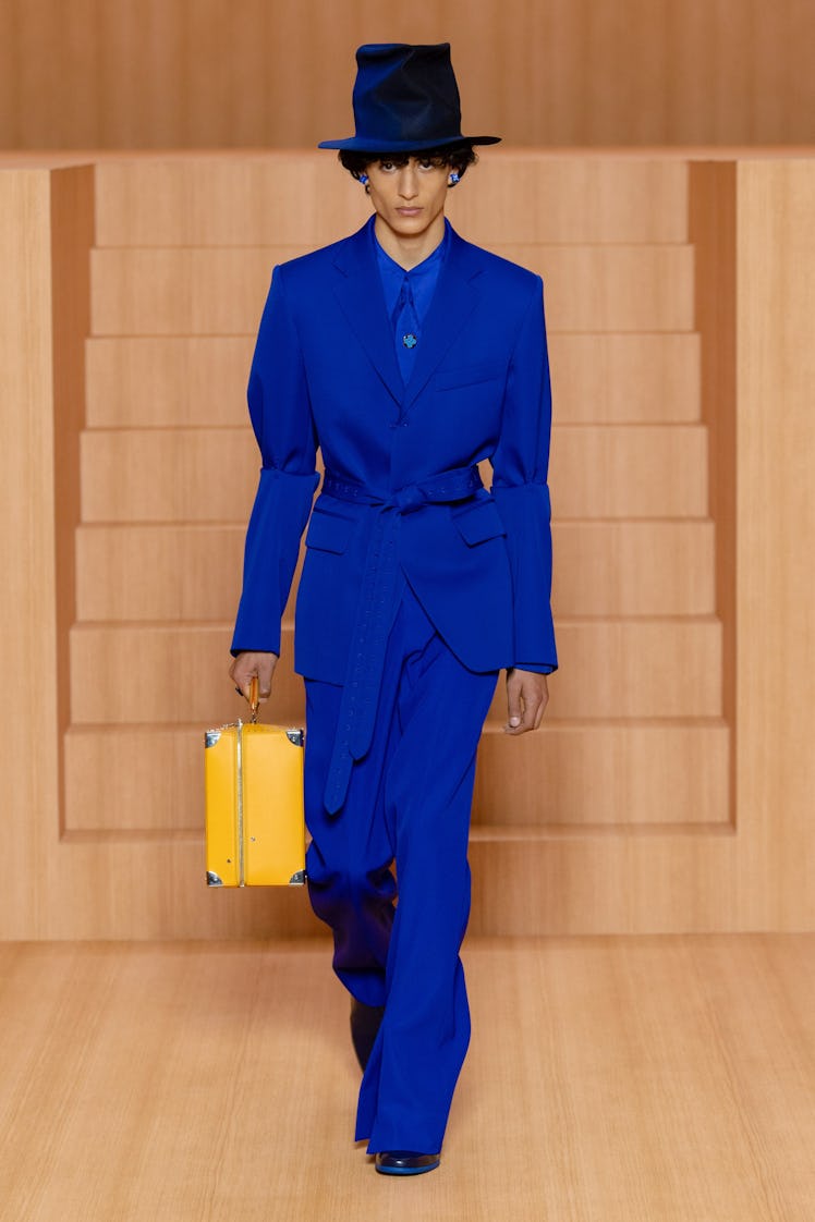 A model in a blue suit and shirt by Louis Vuitton at Men’s Fashion Week Spring 2022
