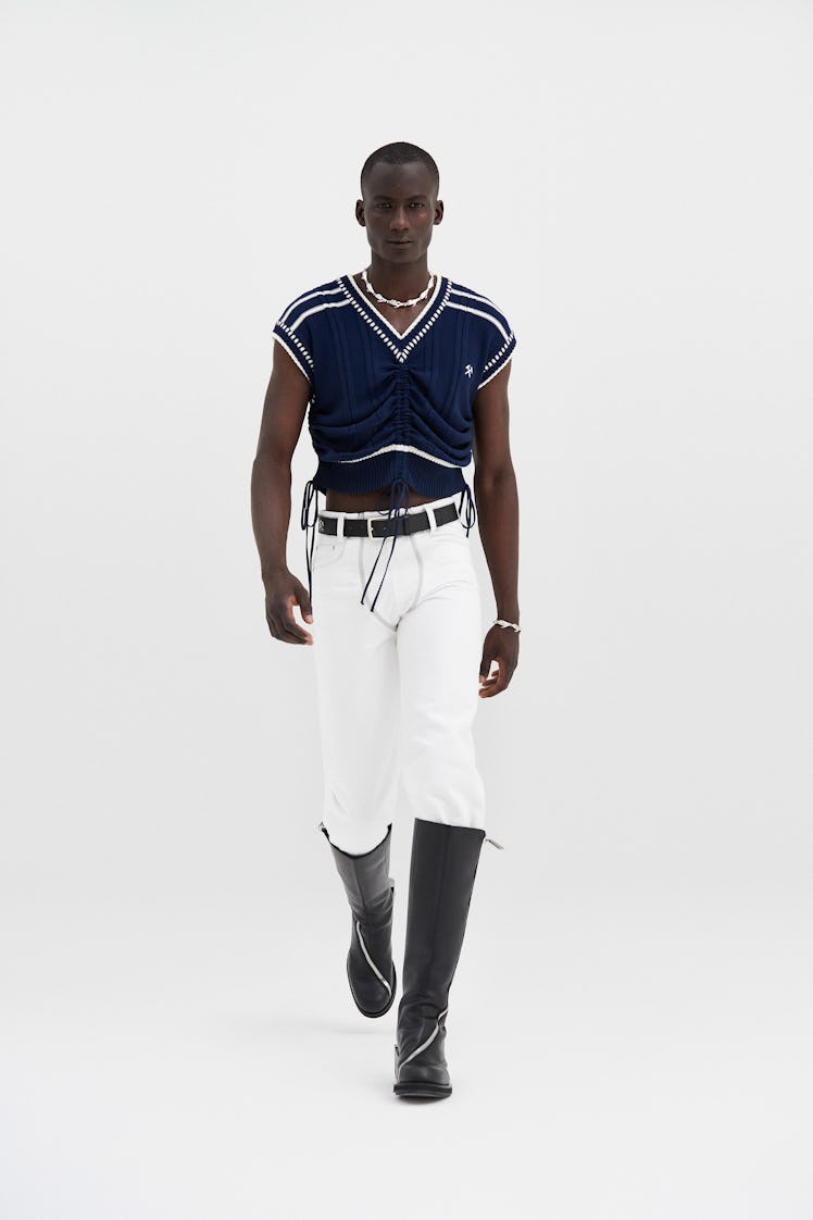 A model in a navy-white top and white trousers by Gmbh at Men’s Fashion Week Spring 2022