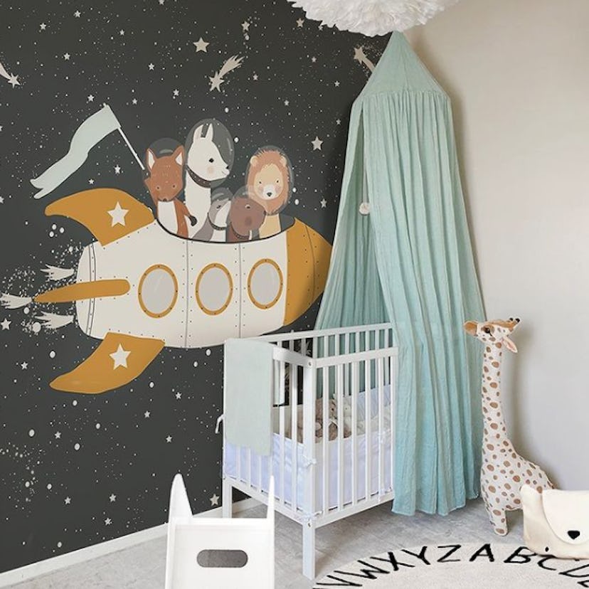 Space-themed wallpaper in baby nursery