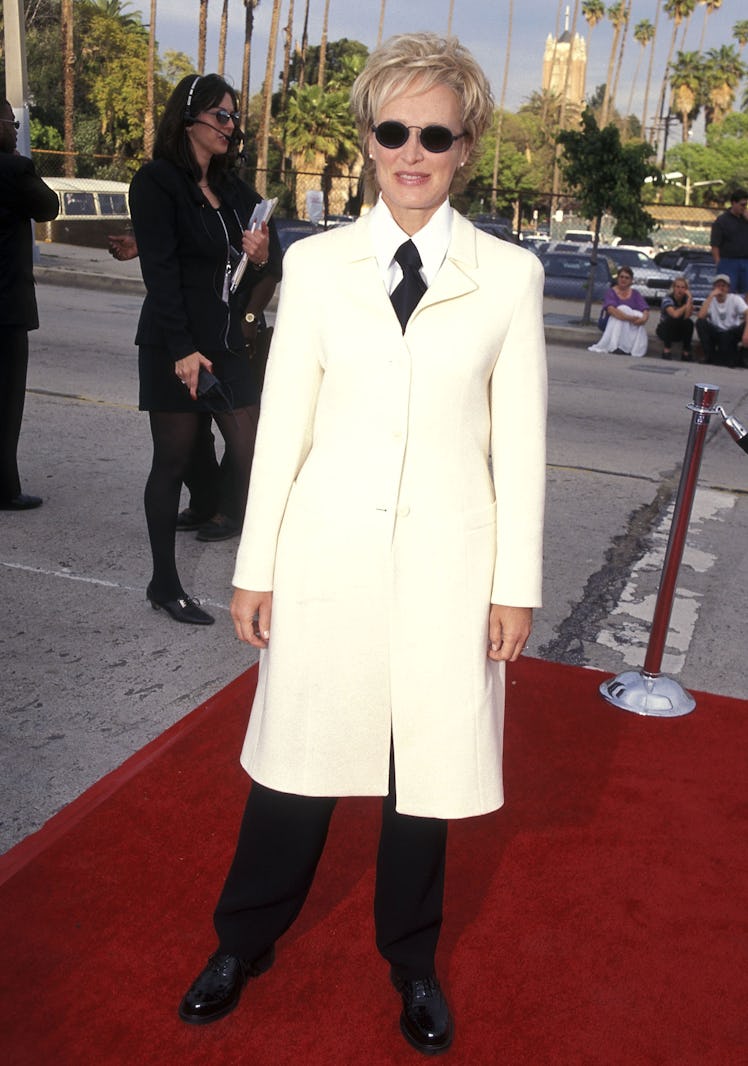 Glenn wears white jacket over suit and tie