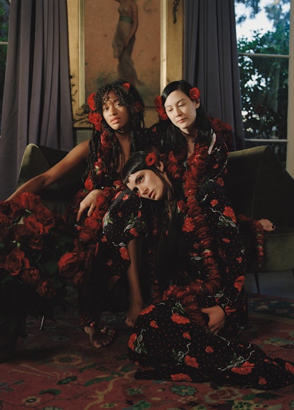 Models posing in black outfits with red roses for Rodarte’s First Pre-Fall Campaign