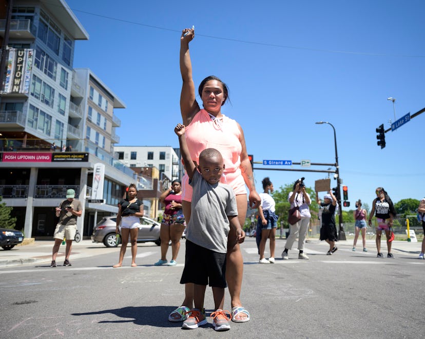 Starr Patterson stood with a child as they raised their first in the intersection of West Lake Stree...