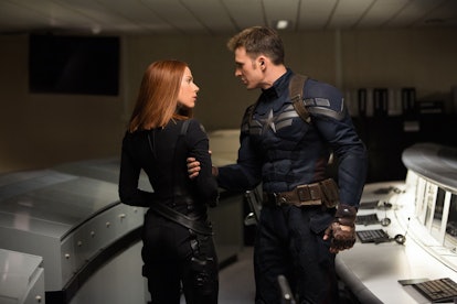 Scarlett Johansson as Black Widow with Chris Evans as Steve Rogers, preparing to go on the run in Ca...