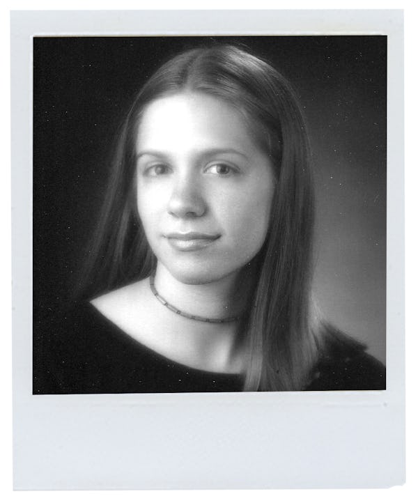 K.Flay at 17. with a long brown hair, wearing a black shirt and a choker necklace