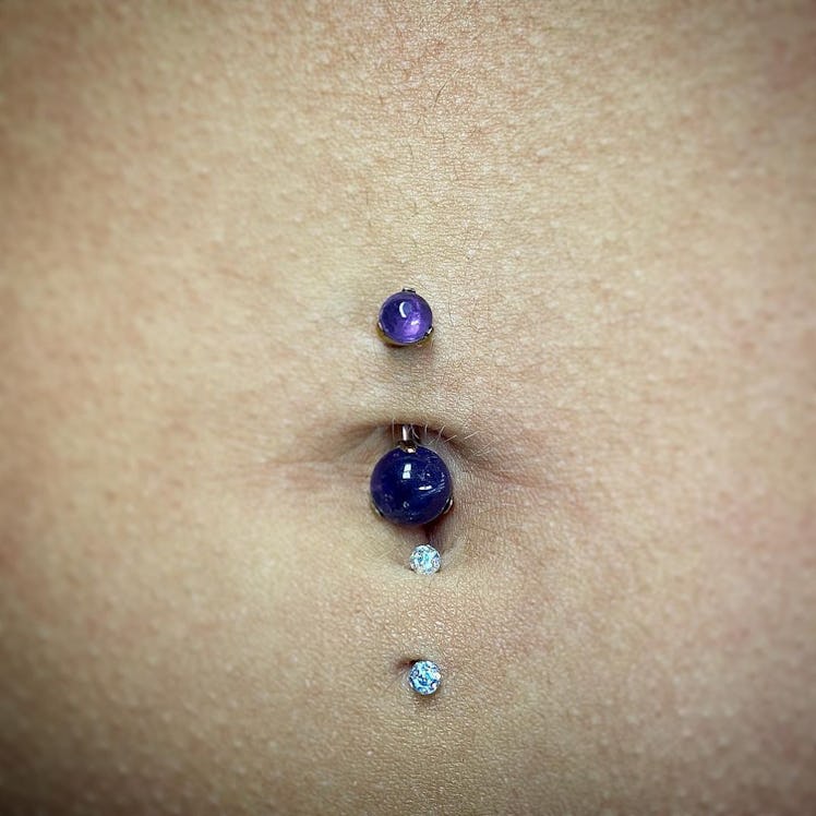 A lower and upper navel piercing performed by Dean Galgano