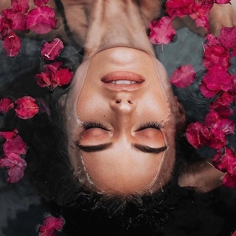 Saint Jane Beauty model in rose petal bath