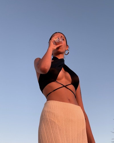 A girl wearing a black top and white dress