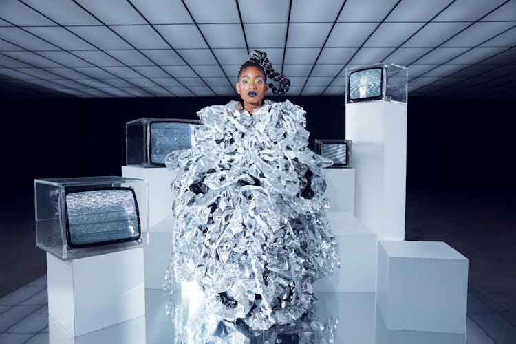 NYLON cover star Willow Smith stands wearing a silver Noir Kei Ninomiya coat.